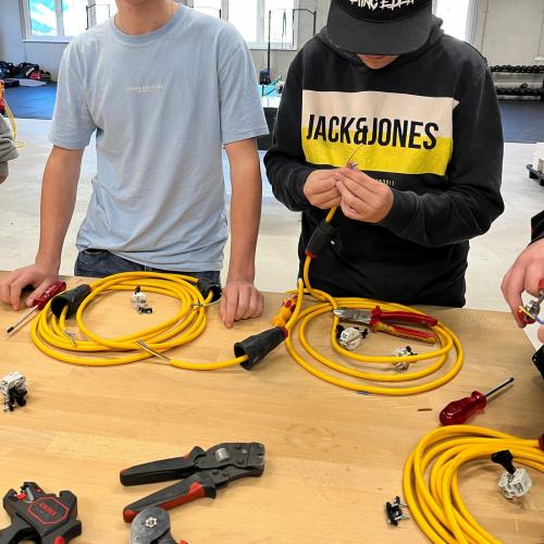 Schüler probiert sich beim Spitzen von Kabeln